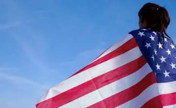 Young woman draped in an American flag