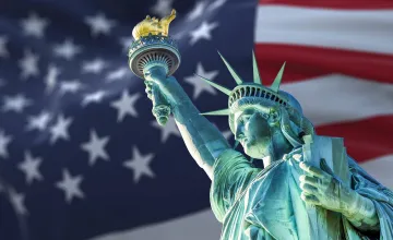 Statue of Liberty Against an American Flag Background