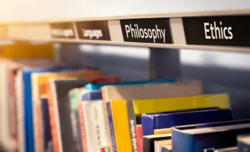 Row of philosophy and ethics books on a library shelf