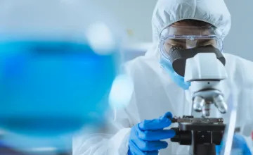 Scientific researcher with a microscope
