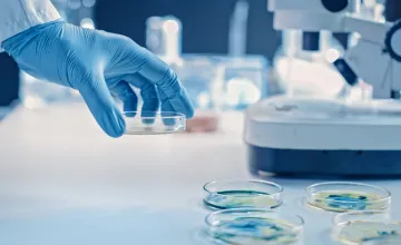 Scientist holding a petri dish in a laboratory