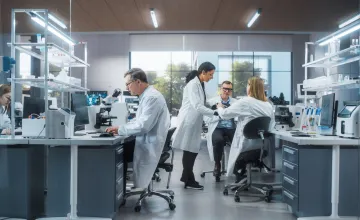 Scientists discussing discoveries in a laboratory