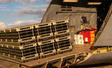 Military cargo getting loaded onto heavy air transport