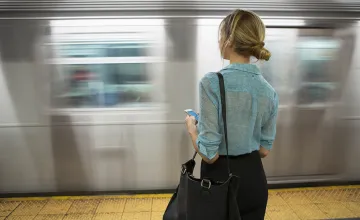 woman waiting for a train in motion