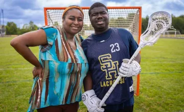 Ray Barrett on a LaCrosse field with his mother