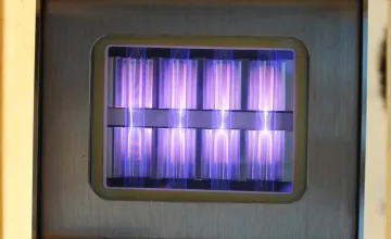 UV light being emitted by a krypton chloride excimer lamp, fueled by molecules moving between different states of energy. (Credit: Linden Research Group)