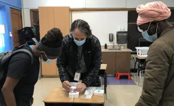Professor Mark Hernandez demonstrates the installation process for the classroom air quality remote sensors