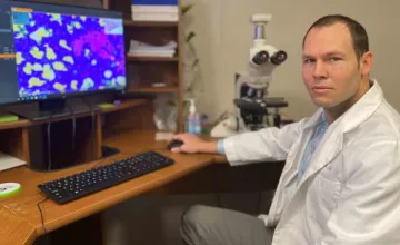 A researcher poses in a lab.