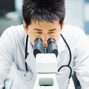 Photo of researcher using a microscope