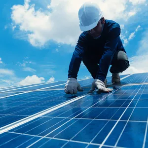worker maintaining solar panels