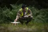 Air Force Sergeant prepares a drone in a wooded area. 