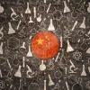 Flag of China surrounded by symbols depicting scientific tools. 