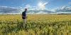 Fulbright awardee standing in a field in Uruguay. 