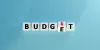 Blocks reading "budget" with the letter E turning over with a red down arrow. 