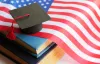 Graduate cap on top of American flag and stack of books