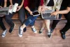 4 students sitting in a row, studying