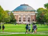 Students walk and socialize on the Quad lawn of the University of Illinois college campus in Urbana Champaign