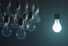 One lit bulb to the right of a group of unlit bulbs