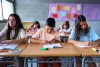 Front view of a group of students working together in a classroom