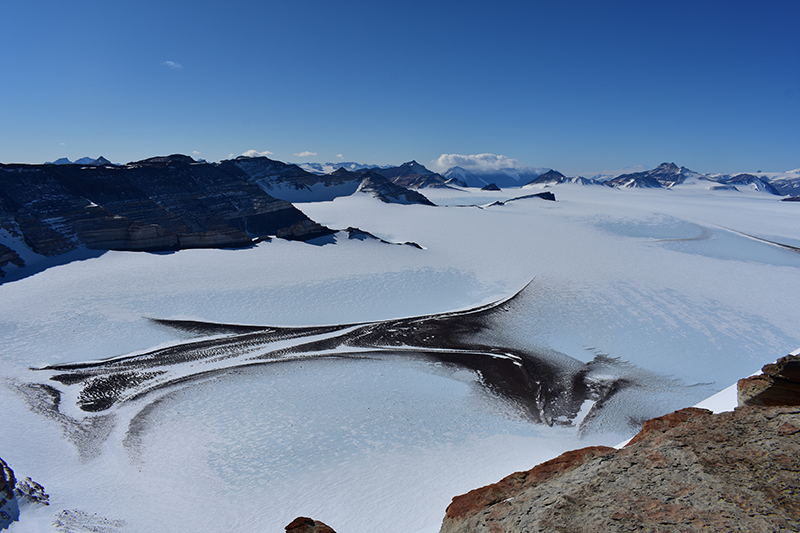 "Speaking stones: Analyzing Antarctica's rocks to explore Earth's past and possible futures.; The rocks in Antarctica’s Dry Valleys are devoid of accumulated ice. They have been exposed to the atmosphere, and almost nothing else, for millions of years, making them excellent vehicles for studying the past. (Purdue University photo courtesy of Marissa Tremblay) Download image"
