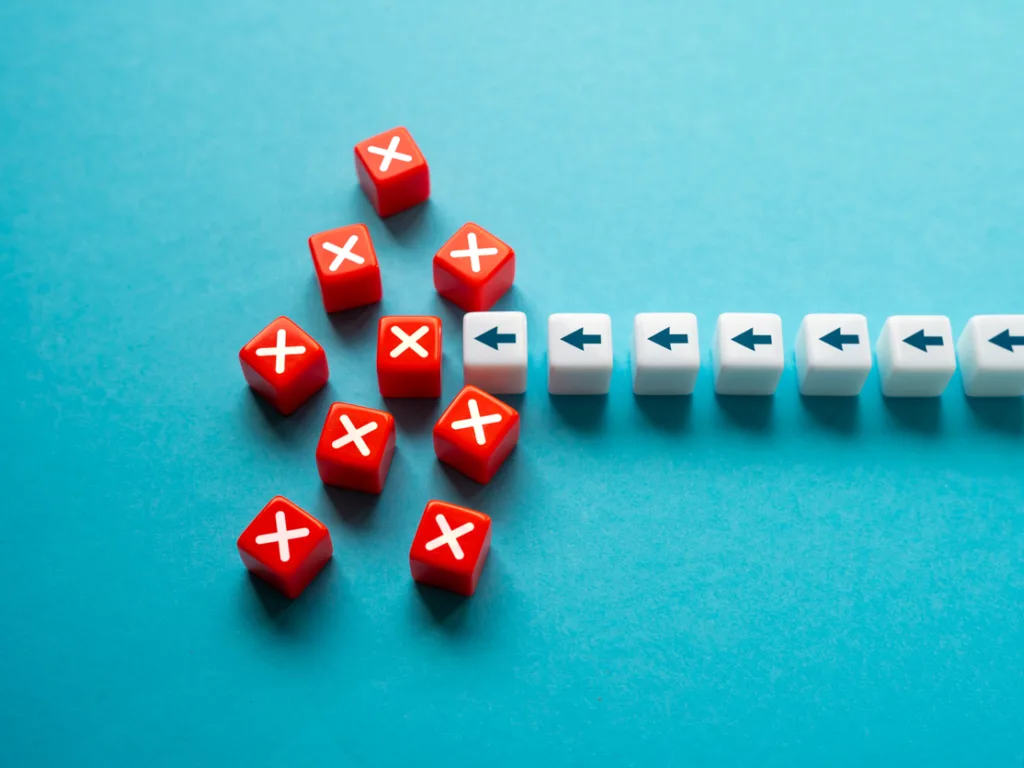 White arrows move in a line toward a mass of red Xs, demonstrating road blocks disrupting progress.